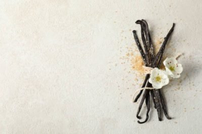 Dried vanilla beans and white flowers for aromatherapy